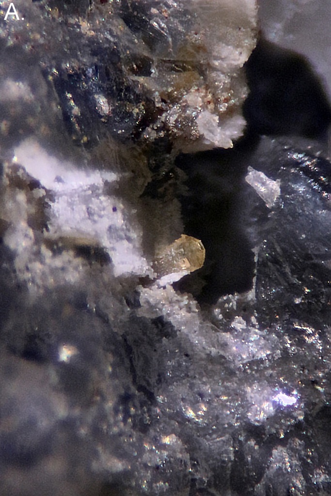 A small, prismatic, transparent yellow quintinite crystal in a vug. 